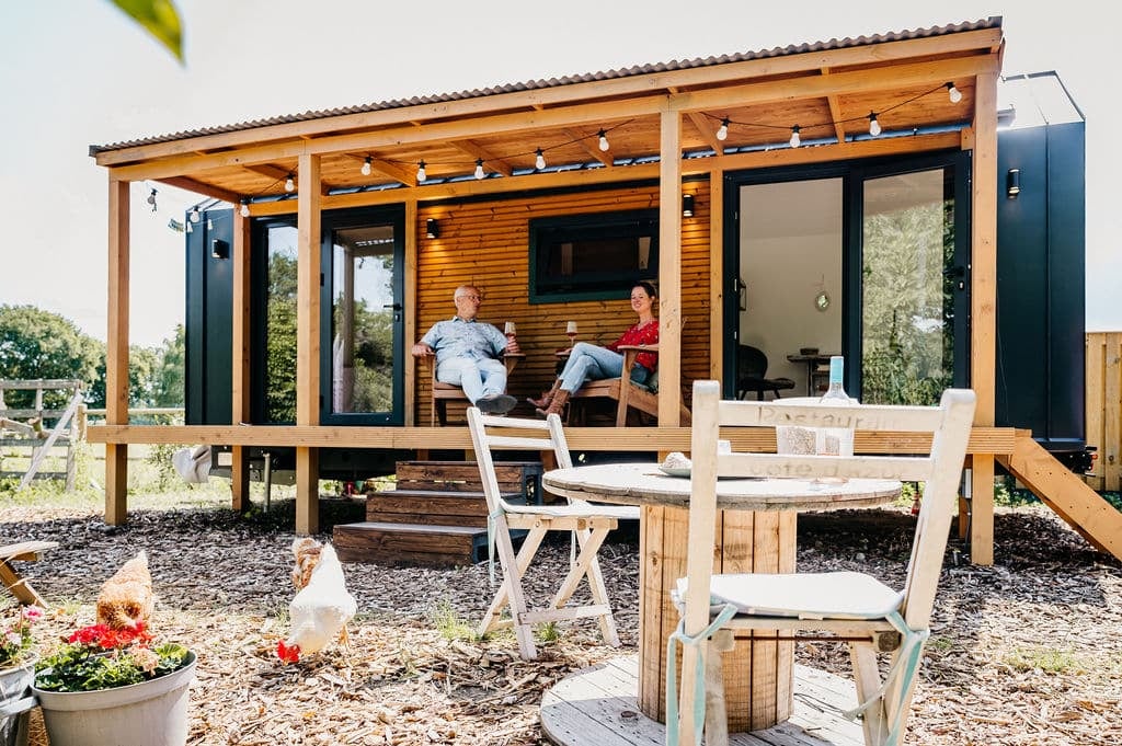 people sitting outside wooden house